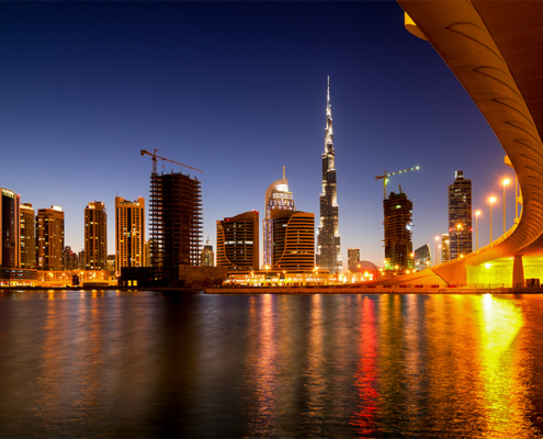 Overlooking harbour in Dubai at night with UHNW individual