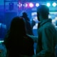 Man and woman in busy nightclub